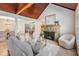 Open-concept living room with fireplace and view into the dining and kitchen areas at 118 S Manhattan Ave, Tampa, FL 33609