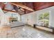 Inviting living room with stone fireplace, wood ceiling, and travertine floors at 118 S Manhattan Ave, Tampa, FL 33609