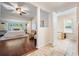 Bright main bedroom boasts a ceiling fan, wood floors, and lots of natural light at 118 S Manhattan Ave, Tampa, FL 33609