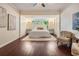 Serene main bedroom with wood floors, large window, and recessed lighting at 118 S Manhattan Ave, Tampa, FL 33609