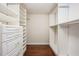 Organized walk-in closet with custom shelving and wood floors at 118 S Manhattan Ave, Tampa, FL 33609