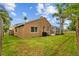 Large backyard with private pool and a green lawn with mature trees at 12009 Wandsworth Dr, Tampa, FL 33626