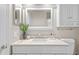 Bright bathroom features a modern vanity, neutral stone counters and decorative touches at 12009 Wandsworth Dr, Tampa, FL 33626