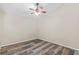 Spacious bedroom features a ceiling fan and stylish laminate floors at 12009 Wandsworth Dr, Tampa, FL 33626