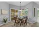 Dining room with backyard pool access, pendant lighting, and seating for four at 12009 Wandsworth Dr, Tampa, FL 33626