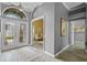 Inviting foyer with a decorative glass front door, tile flooring, and gray walls at 12009 Wandsworth Dr, Tampa, FL 33626