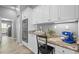 Close up of the kitchen featuring stone countertops, white cabinetry and stainless oven at 12009 Wandsworth Dr, Tampa, FL 33626