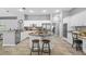 Spacious eat-in kitchen with central island, white cabinetry, modern appliances, and tile flooring at 12009 Wandsworth Dr, Tampa, FL 33626