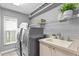 Well-equipped laundry room with modern appliances, a sink, and plenty of storage at 12009 Wandsworth Dr, Tampa, FL 33626