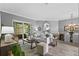 Bright living room with a comfortable seating area, neutral tones, and access to the patio at 12009 Wandsworth Dr, Tampa, FL 33626