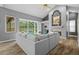 Comfortable living room with vaulted ceilings, fireplace, access to pool area, and stylish furniture at 12009 Wandsworth Dr, Tampa, FL 33626