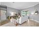 Spacious living room with tile flooring, neutral walls, and a view of the outdoor pool at 12009 Wandsworth Dr, Tampa, FL 33626