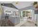 Open concept living room with tile floors, neutral furniture, fireplace, and access to outdoor space at 12009 Wandsworth Dr, Tampa, FL 33626