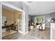 Open-concept living room with wood-look floors, neutral tones, and a view to the outside at 12009 Wandsworth Dr, Tampa, FL 33626