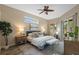 Bright main bedroom featuring a ceiling fan, wood floors, and sliding glass doors to the outdoors at 12009 Wandsworth Dr, Tampa, FL 33626