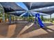 Community playground with shade structure, slide, climbing area, and swings in a well-maintained common area at 12009 Wandsworth Dr, Tampa, FL 33626