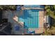 Overhead view of a large community pool with lounge areas, lap lanes, and shade structures at 12009 Wandsworth Dr, Tampa, FL 33626