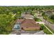 Back of the home with a screened-in pool area, landscaped backyard, and view of the surrounding neighborhood at 12009 Wandsworth Dr, Tampa, FL 33626