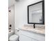 Modern bathroom featuring granite counters, white vanity, and tub with tiled shower at 12074 Manassas Ave, Weeki Wachee, FL 34614