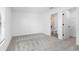 Bright bedroom featuring a neutral color palette, carpet flooring, and en-suite bathroom at 12074 Manassas Ave, Weeki Wachee, FL 34614