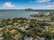 Beautiful aerial view of a residential area featuring lush greenery, a bay, and a city skyline in the background at 122 Miramar Ne Blvd, St Petersburg, FL 33704