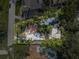 Expansive aerial view showing the home's layout, surrounded by lush landscaping, a pool, and a defined property line at 122 Miramar Ne Blvd, St Petersburg, FL 33704