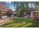 Expansive backyard featuring a well-manicured lawn, lush landscaping, and cozy outdoor seating areas at 122 Miramar Ne Blvd, St Petersburg, FL 33704