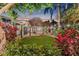 Landscaped backyard featuring a lawn, mature trees and flowerbeds at 122 Miramar Ne Blvd, St Petersburg, FL 33704