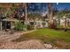The backyard features an inviting outdoor space, with lush greenery and ambient lighting, perfect for relaxation and entertaining at 122 Miramar Ne Blvd, St Petersburg, FL 33704