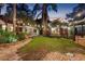 Beautiful backyard with a well-manicured lawn, lush landscaping, and charming string lights, creating a serene oasis at 122 Miramar Ne Blvd, St Petersburg, FL 33704
