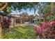 Expansive backyard with lush tropical landscaping, patio, and classic style architecture at 122 Miramar Ne Blvd, St Petersburg, FL 33704