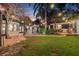 Beautiful backyard with mature trees, string lights, and outdoor seating area at 122 Miramar Ne Blvd, St Petersburg, FL 33704