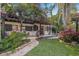 Charming backyard with lush landscaping, stone walkway, and cozy pergola at 122 Miramar Ne Blvd, St Petersburg, FL 33704