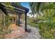Charming backyard featuring a pergola, lush landscaping, and stone pathway for outdoor living and enjoyment at 122 Miramar Ne Blvd, St Petersburg, FL 33704