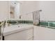 Stylish bathroom with a white sink vanity and green tiled backsplash at 122 Miramar Ne Blvd, St Petersburg, FL 33704