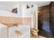 Bathroom showcasing a soaking tub with tiled walls, a dark-tiled shower, and a small wicker stool at 122 Miramar Ne Blvd, St Petersburg, FL 33704