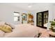 Bright bedroom boasts a ceiling fan, tile floors, and French doors to the garden at 122 Miramar Ne Blvd, St Petersburg, FL 33704