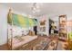 bedroom with a tented bed, colorful rug, and access to another room, exuding creativity at 122 Miramar Ne Blvd, St Petersburg, FL 33704
