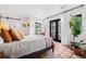 Airy bedroom with light-colored tiled floors and garden views from French doors at 122 Miramar Ne Blvd, St Petersburg, FL 33704