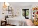 Cozy bedroom features a queen-size bed, unique art, and a door leading to the outside at 122 Miramar Ne Blvd, St Petersburg, FL 33704