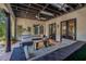 Inviting covered patio featuring ample seating, terracotta flooring, and view to the beautiful yard for relaxation at 122 Miramar Ne Blvd, St Petersburg, FL 33704