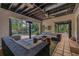 Spacious covered patio with comfortable seating, ceiling fan, and an open view of the lush backyard at 122 Miramar Ne Blvd, St Petersburg, FL 33704