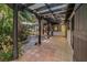 Relaxing covered patio with tile flooring and lush greenery, perfect for outdoor enjoyment at 122 Miramar Ne Blvd, St Petersburg, FL 33704
