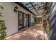 Covered patio with dark wood accents, tiled floor, and direct access to multiple rooms at 122 Miramar Ne Blvd, St Petersburg, FL 33704