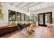 Bright dining room with cozy bench seating, garden views, and modern light fixture at 122 Miramar Ne Blvd, St Petersburg, FL 33704