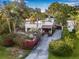 Charming home with tile roof, lush landscaping, and a private driveway with a gated entrance at 122 Miramar Ne Blvd, St Petersburg, FL 33704