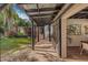 Exterior view of a covered walkway leading to the home with stone pavers, seating, and lush garden views at 122 Miramar Ne Blvd, St Petersburg, FL 33704