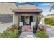 Charming home featuring a covered front entrance with terracotta tiles and vibrant landscaping at 122 Miramar Ne Blvd, St Petersburg, FL 33704