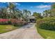 A charming home exterior featuring lush landscaping, a private gated entry, and a welcoming entrance at 122 Miramar Ne Blvd, St Petersburg, FL 33704