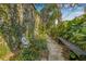 Peaceful garden pathway featuring lush greenery and a tranquil Buddha statue at 122 Miramar Ne Blvd, St Petersburg, FL 33704